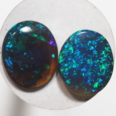 SOLID BLACK OPALS Matching pair. Bright green sparkles constantly